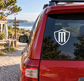 Shield crest vinyl decal on car rear window, black-and-white emblem
