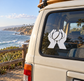 White vinyl decal of two hands catching a cricket ball on a car window