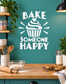 Vinyl wall decal with white 'BAKE SOMEONE HAPPY' text and cupcake icon with rays