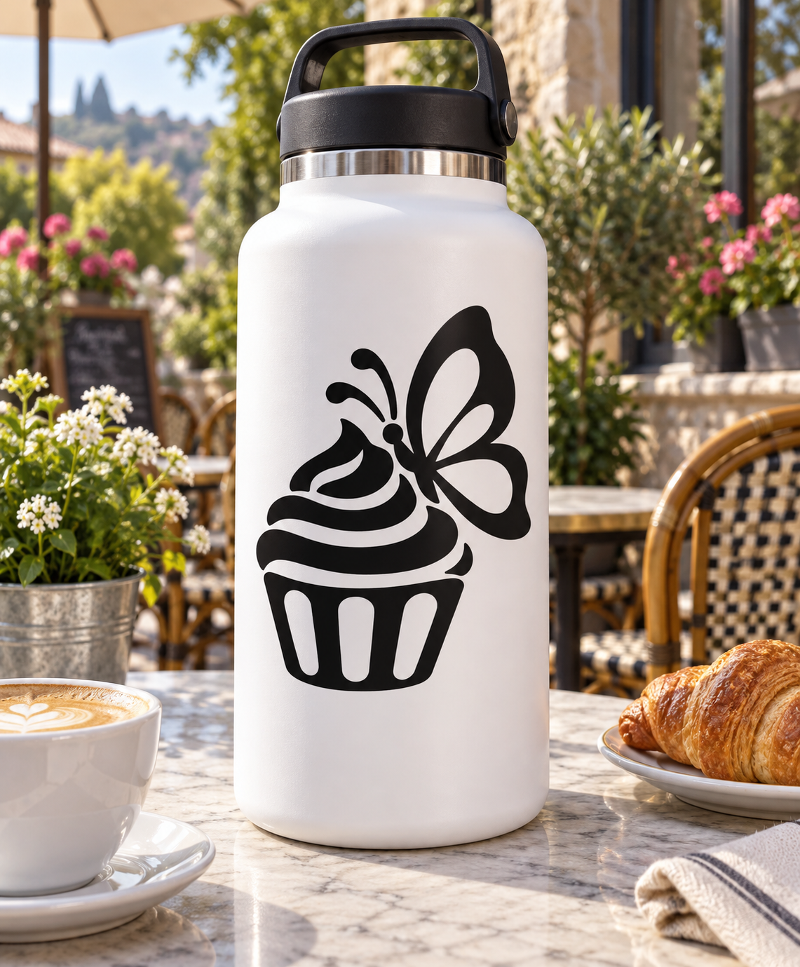 Black vinyl decal of a cupcake with butterfly, applied on a white bottle