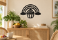 Black cupcake-and-rainbow vinyl wall decal with rainbow arches, cupcake, and clouds