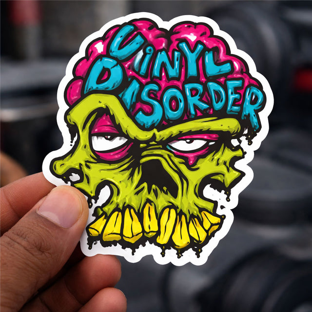 Graffiti skull sticker with neon blue, pink, and yellow monster eyes and dripping mouth