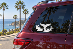 White whale tail horizon vinyl decal on car rear window with sailboat and waves