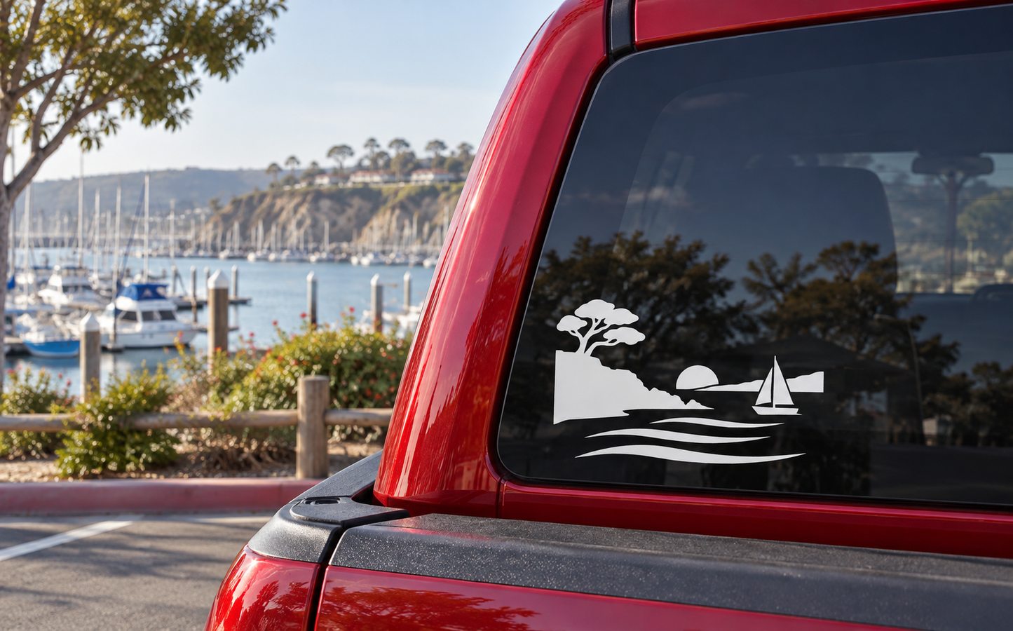 Coastal headlands vinyl decal with tree silhouette, sailboat, cliffs, and wave lines on a car
