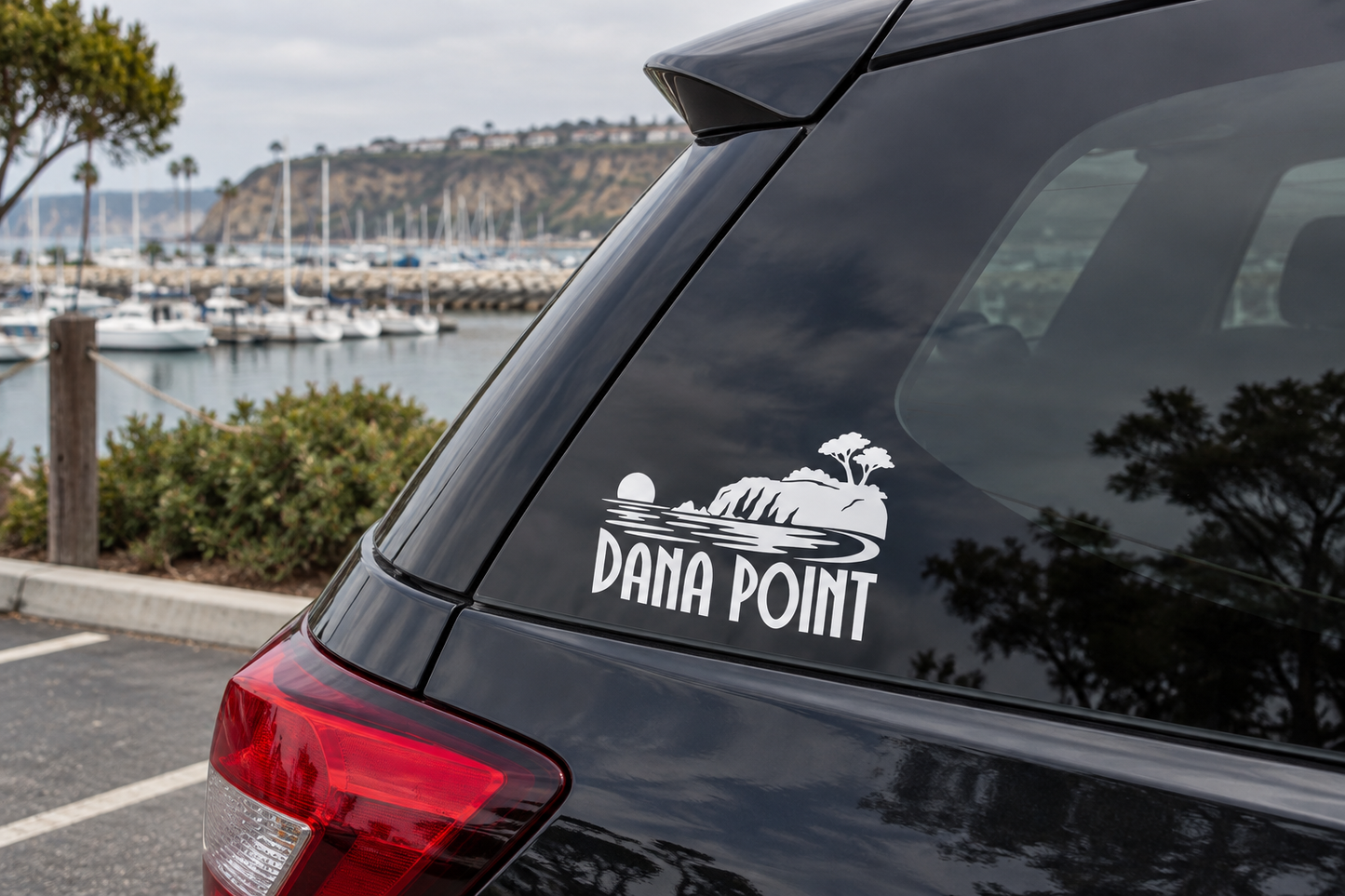 Dana Point headlands wordmark vinyl decal on black car trunk panel