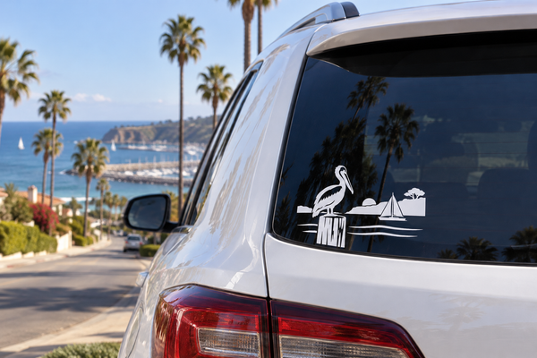 Pelican horizon vinyl decal on car rear window, black and white harbor scene
