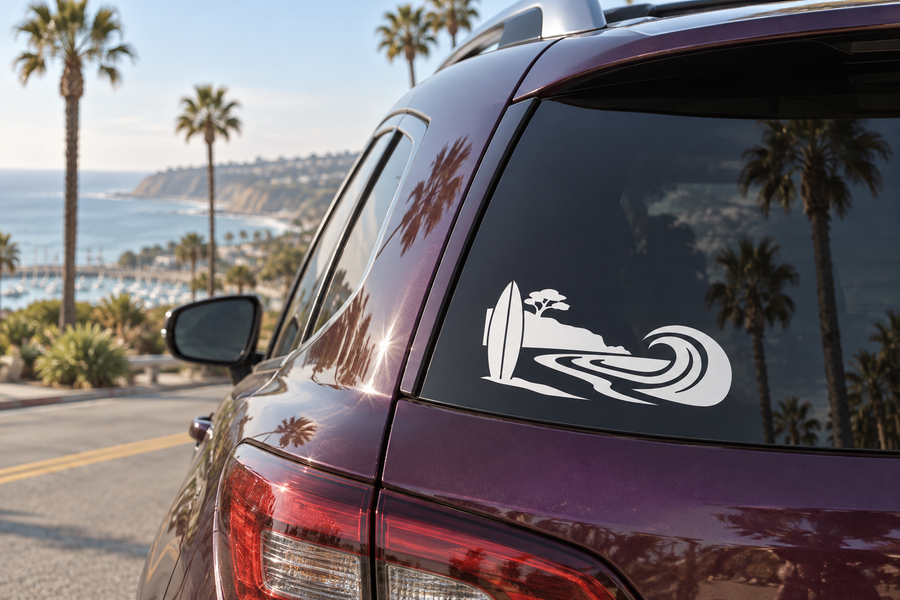 Surfboard and wave icon vinyl decal on a car rear window