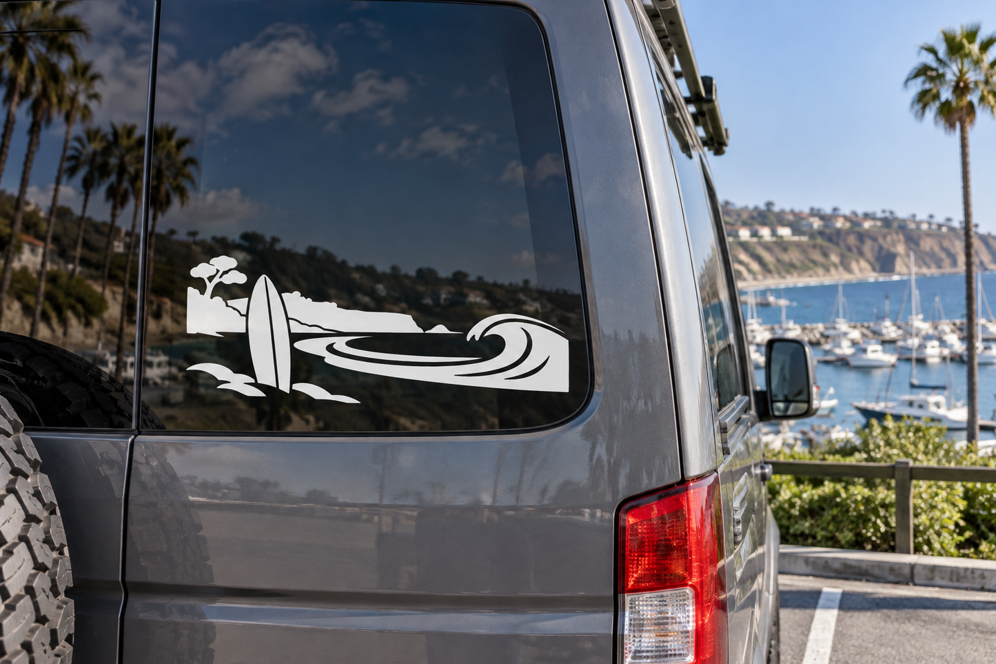 Black vinyl car window decal with surfboard, waves, and palm tree silhouettes