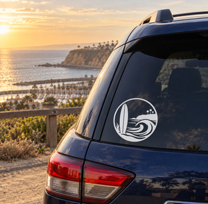 Circular white surf crest vinyl decal on dark car window