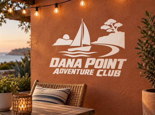 White vinyl decal with sailboat, waves, tree and “Dana Point Adventure Club” lettering.