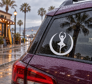 White circular ballerina vinyl decal on a car rear window with crescent border