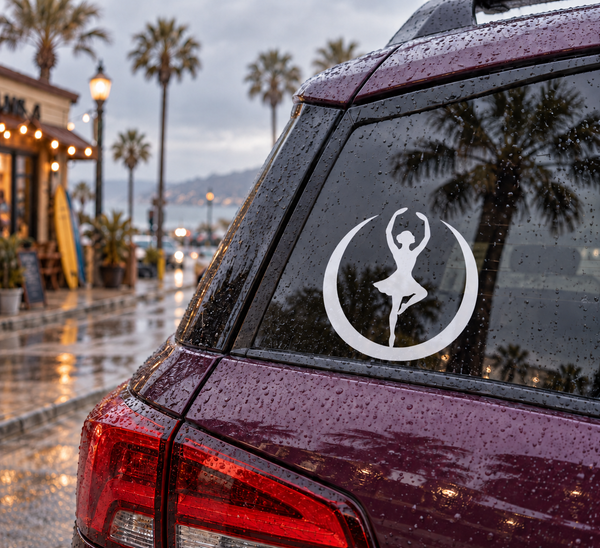 White circular ballerina vinyl decal on a car rear window with crescent border