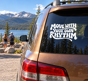 Car window vinyl decal with "Move With Your Own Rhythm" text, white on dark
