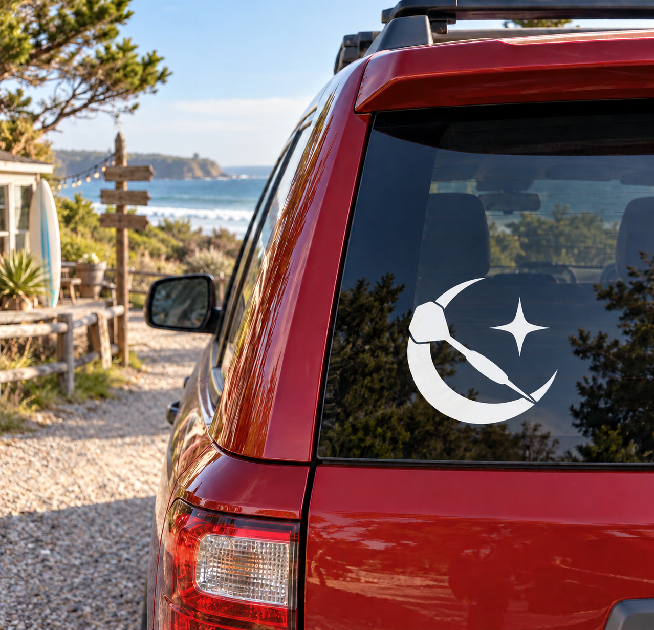 White crescent-and-dart vinyl decal on car rear window