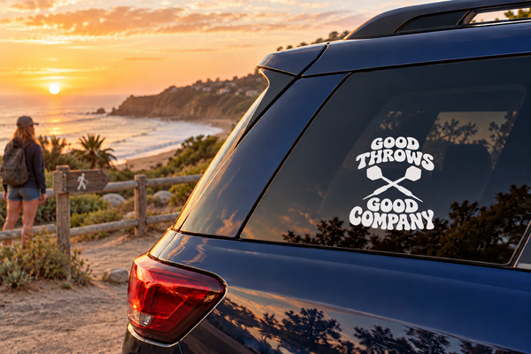 Car window vinyl decal with crossed darts and “Good Throws Good Company” text