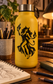 Yellow water bottle with black flame dancer vinyl decal on front