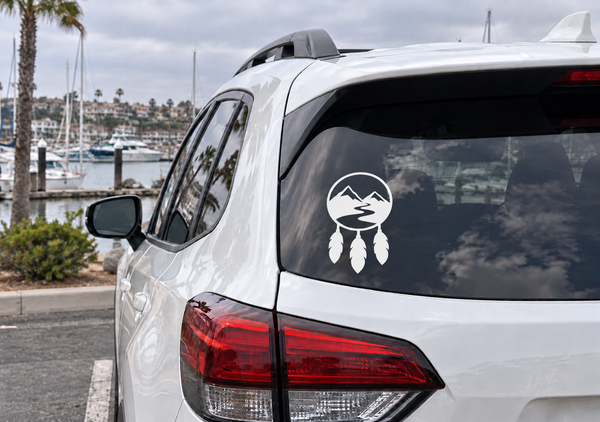 Mountain dreamcatcher vinyl decal with circular mountain and feather icons on car glass