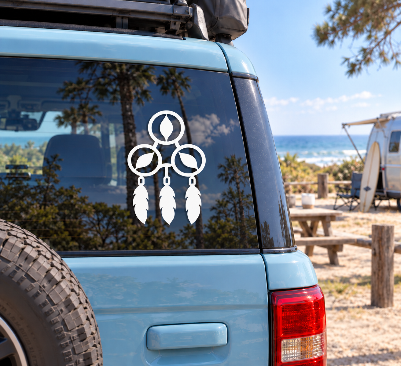 Triple hoop dreamcatcher vinyl decal on car window, black and white with three hanging feathers