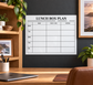White dry-erase lunch box plan panel with weekly grid and headings for main, fruit & extras