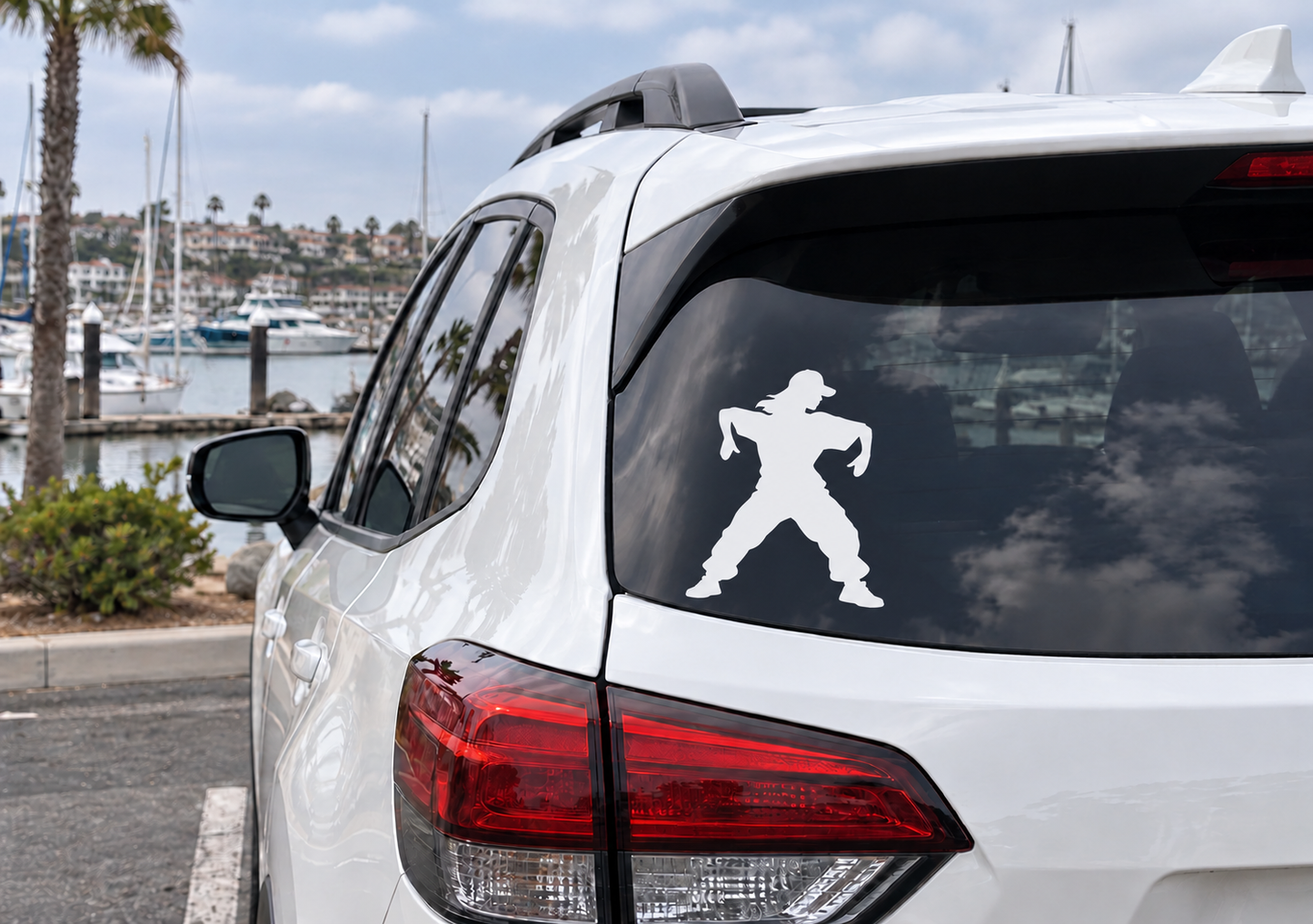 Dancing vinyl decal with two sneakered silhouette figures on a car tail light area