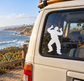 White vinyl decal of a dancing figure with raised hands on a car window