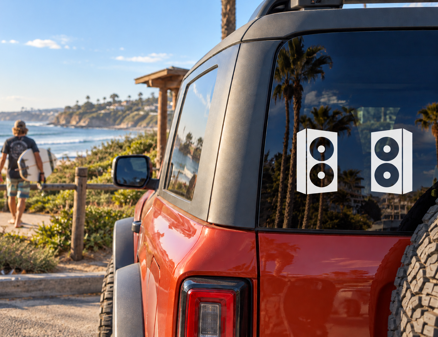 Vinyl speaker cabinet decals on a car window: two black cabinets with white circles