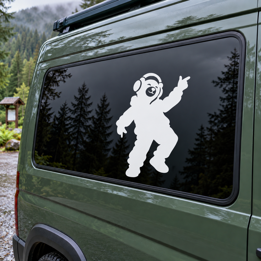 White bear DJ vinyl decal with headphones, arms raised on dark car window