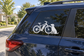 E-bike dog ride vinyl decal: white bicycle and dog silhouette on car window.