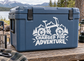 E-bike charged for adventure vinyl decal on blue cooler: e-bike, mountains, text