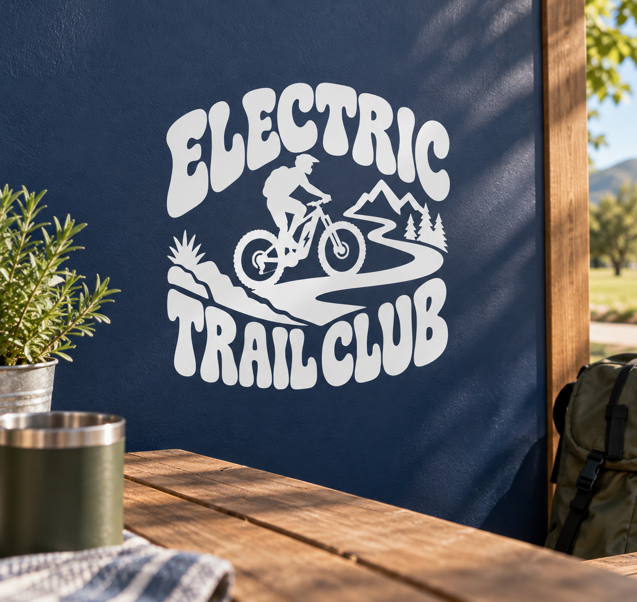 Electric trail club vinyl decal with rider, mountains, and 'ELECTRIC TRAIL CLUB' text