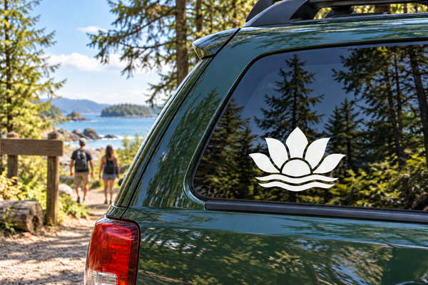 Lotus vinyl decal on car window: black lotus with white outline and wave base.