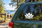Lotus vinyl decal on car window: black lotus with white outline and wave base.