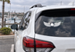 Winged sun arc vinyl decal on car rear window, white winged emblem with sun center