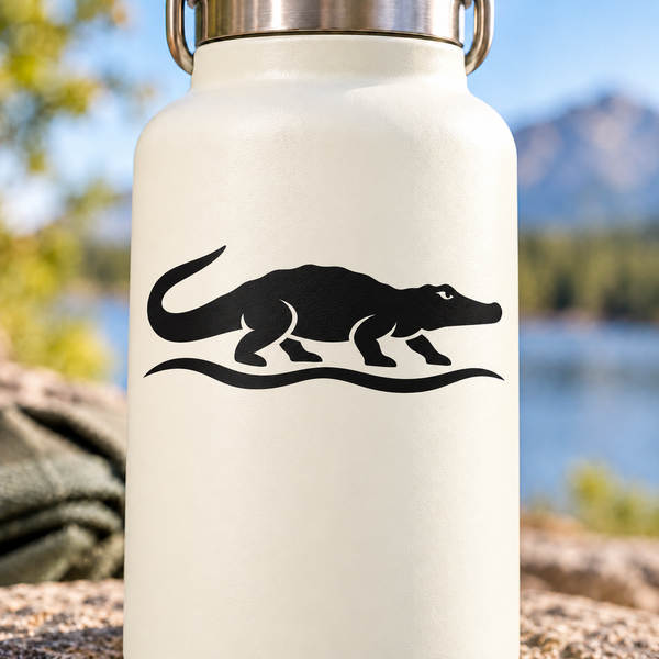 Black crocodile river vinyl decal silhouette with footprints on a light surface