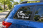 Electric vehicle vinyl decal of a white car with leaves and charging plug on rear window