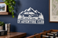 White EV Adventure Club vinyl decal with EV car, mountain peaks, and evergreen trees