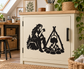 Black vinyl decal of an elf tending a campfire with a kettle hanging from a tripod