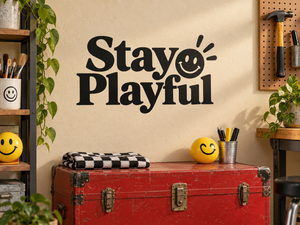 Black vinyl decal reading “Stay Playful” with smiling emoji face and sunburst rays