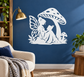 White vinyl book nook decal of a fairy reading under a large spotted mushroom.