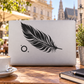 Feather silhouette graphic on light rectangle with small dot and ring accents