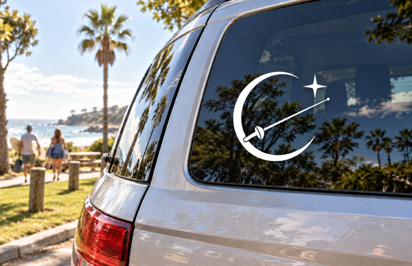 Crescent-line vinyl decal with diagonal line, dot, and star on car window