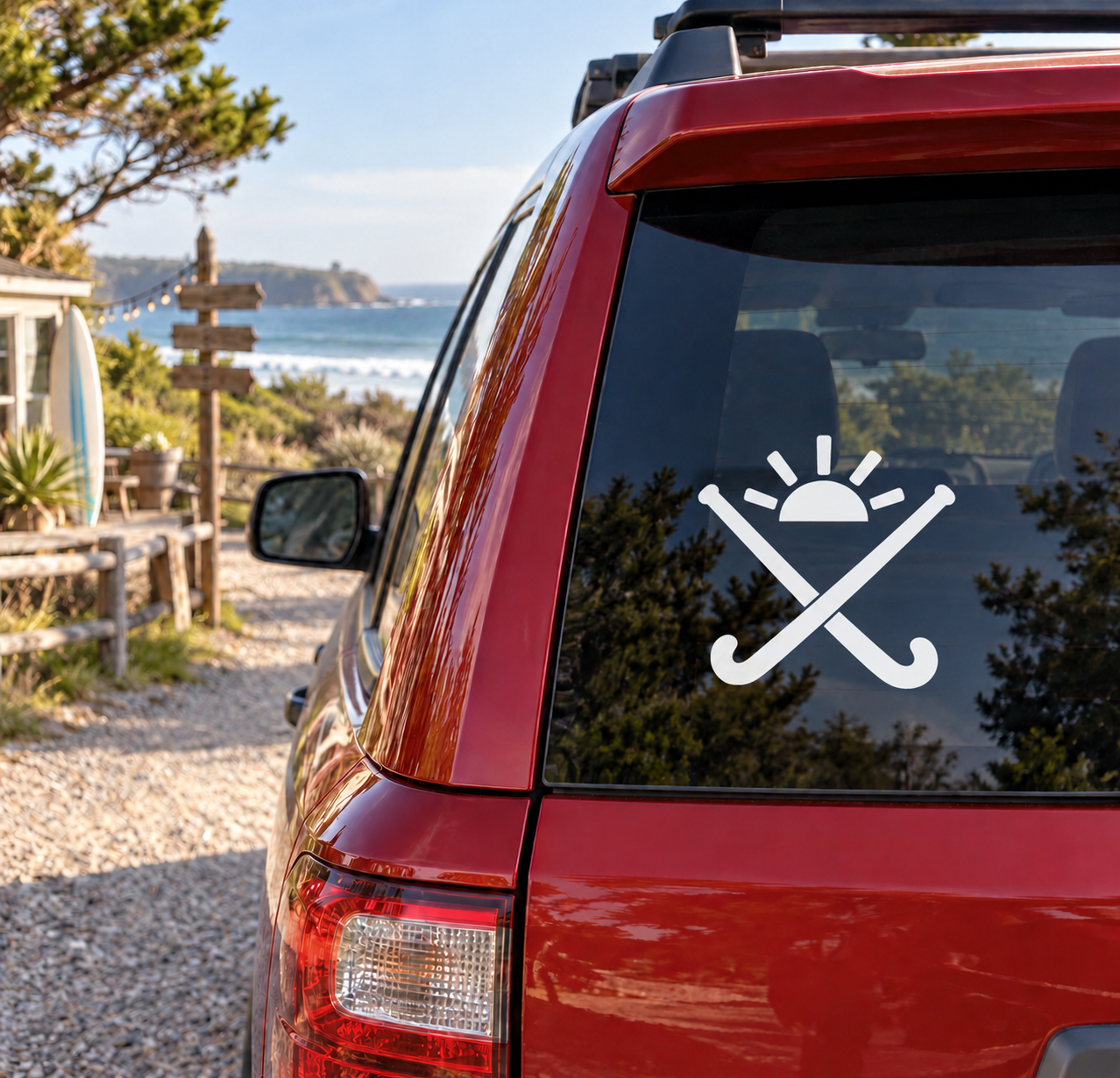 Field hockey vinyl decal with white sun and crossed sticks on car window