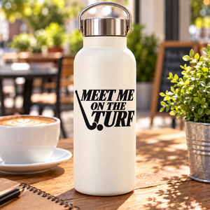 Vinyl decal "MEET ME ON THE TURF" on a white bottle