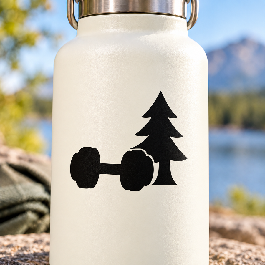Black vinyl decal of dumbbell and pine tree silhouette on a light bottle background