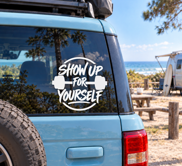 Fitness vinyl decal: white 'Show Up for Yourself' text with dumbbells on car window