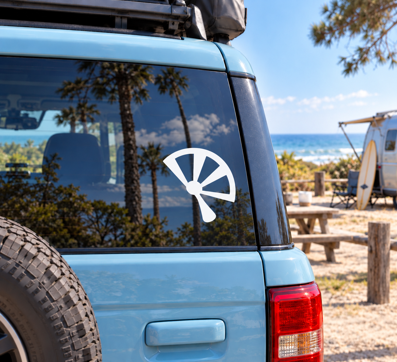 Vinyl decal of stylized open fan symbol in white on a dark background