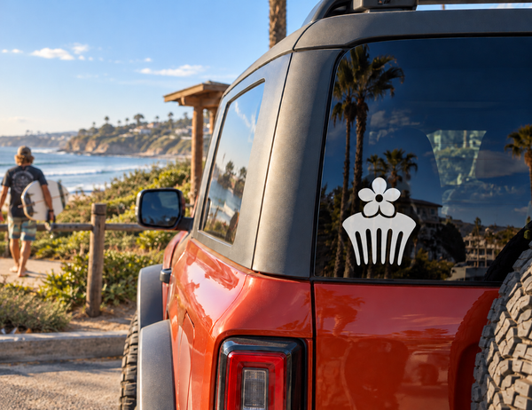 White flower comb vinyl decal on a red vehicle window