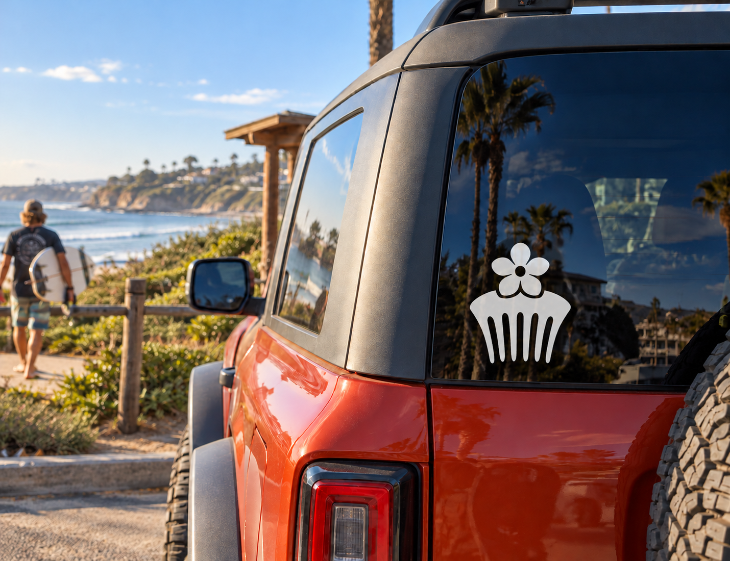 White flower comb vinyl decal on a red vehicle window