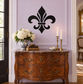 Black fleur-de-lis vinyl decal for wall, centered on a panel door.