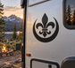Black fleur-de-lis and crescent vinyl decal on a light camper surface